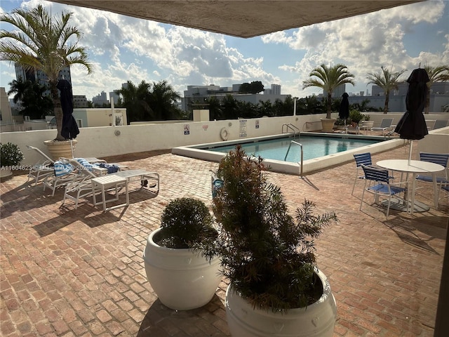 view of swimming pool featuring a patio area