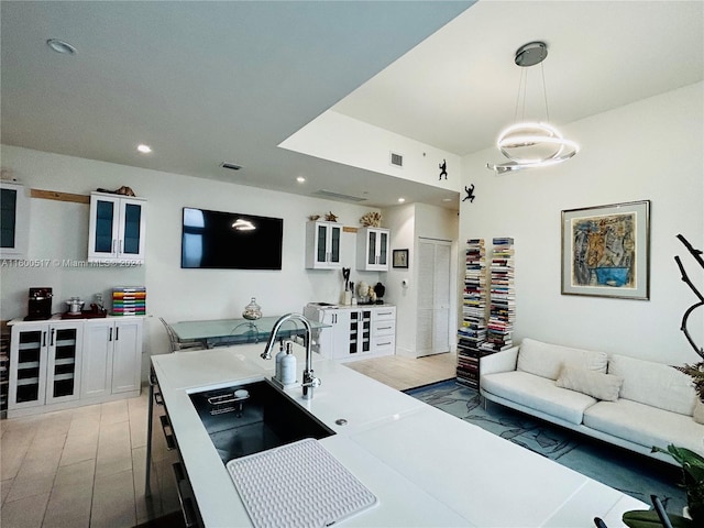 interior space with hanging light fixtures and white cabinets