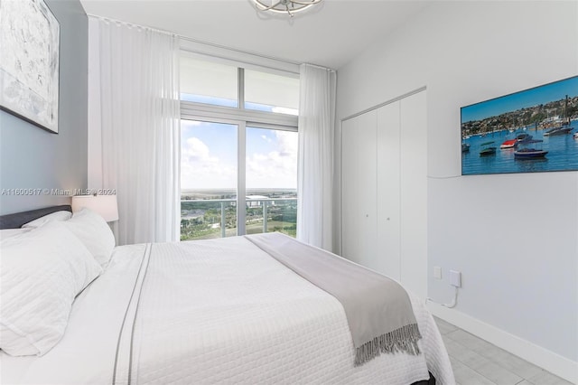 bedroom featuring a closet and light tile flooring