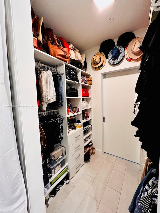 spacious closet featuring light tile flooring