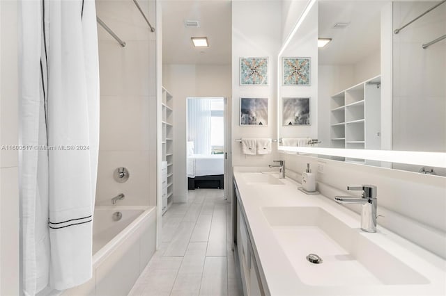 bathroom featuring tile floors, double sink, oversized vanity, and shower / bath combo with shower curtain