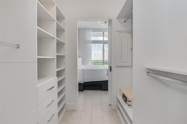 spacious closet with light tile floors