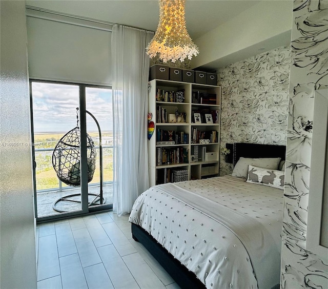 tiled bedroom featuring a notable chandelier, access to outside, and multiple windows