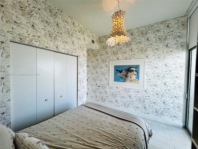 bedroom featuring a closet and a chandelier