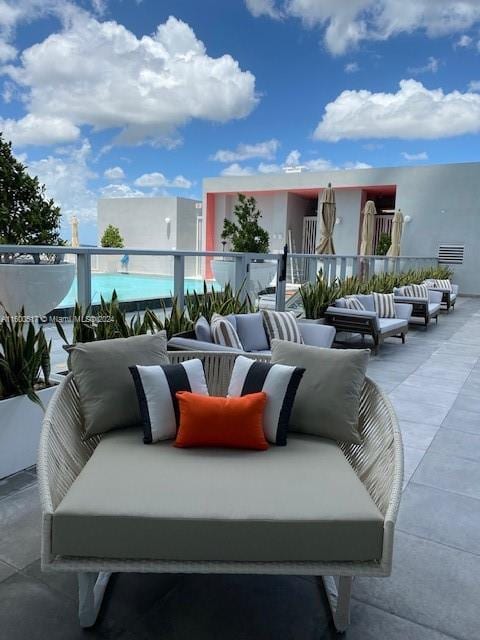 view of patio with an outdoor living space and a balcony