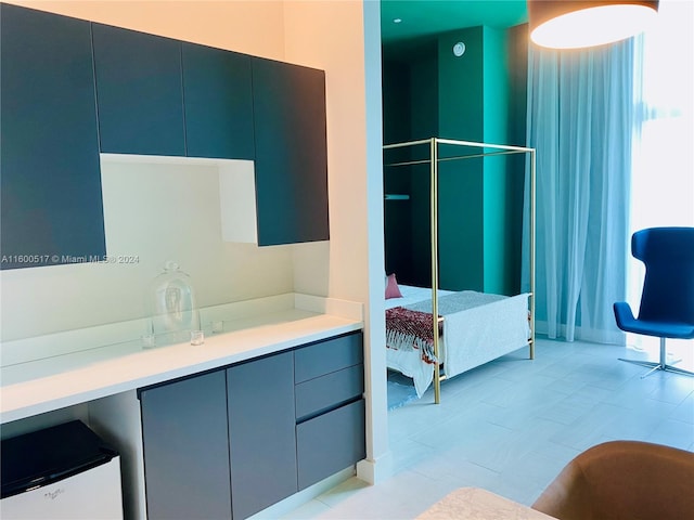 bathroom with tile flooring, vanity, and a wealth of natural light