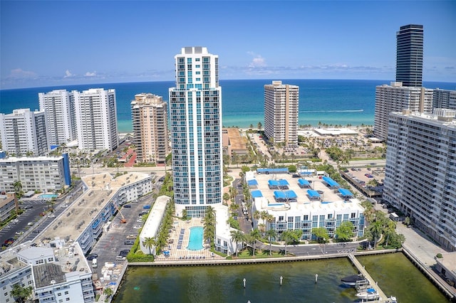 drone / aerial view featuring a view of city and a water view