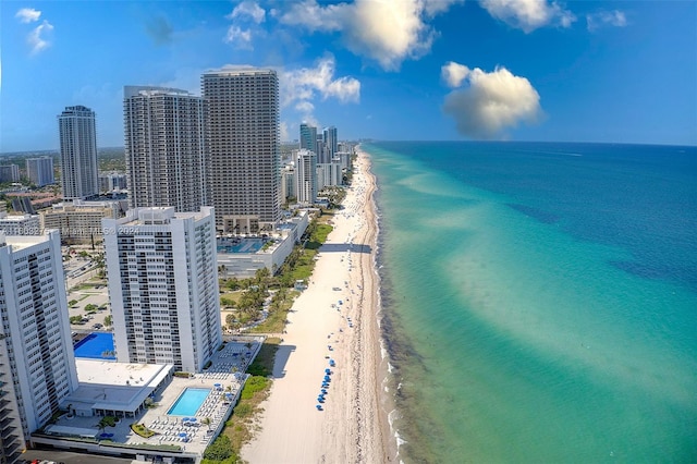 birds eye view of property with a beach view and a water view