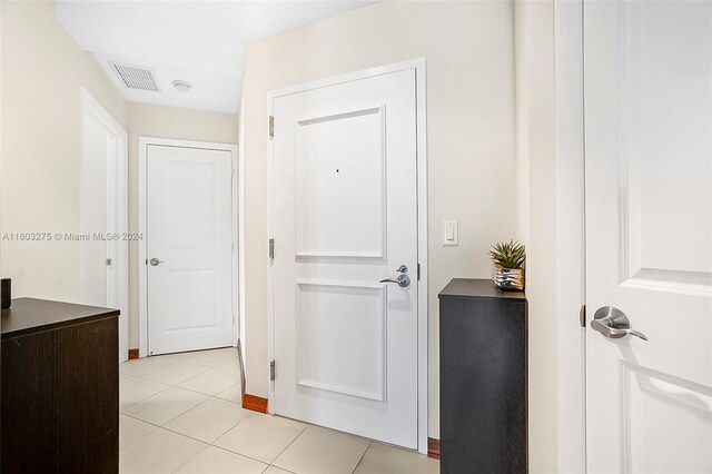 hall featuring light tile floors