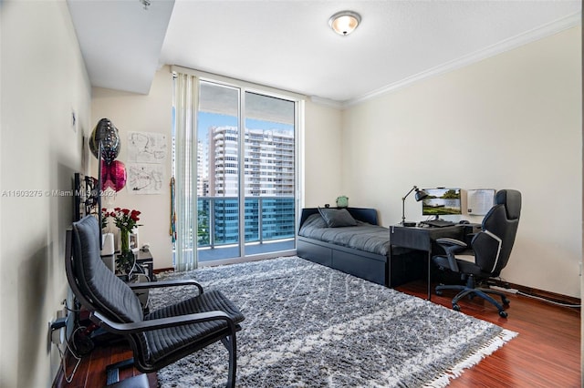 office area with ornamental molding and hardwood / wood-style flooring