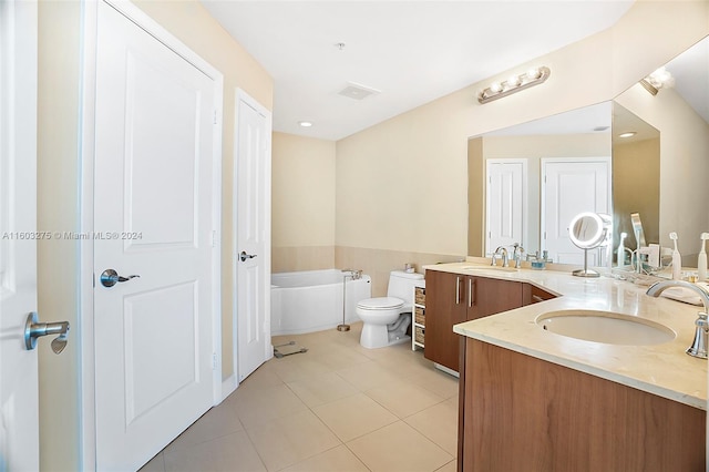 bathroom with dual vanity, a washtub, toilet, and tile floors