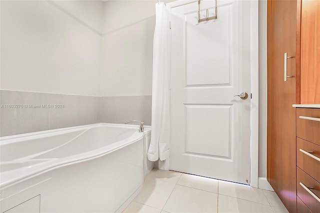 bathroom with vanity, a bath, and tile patterned floors