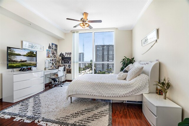 bedroom with ceiling fan, ornamental molding, and dark wood-type flooring