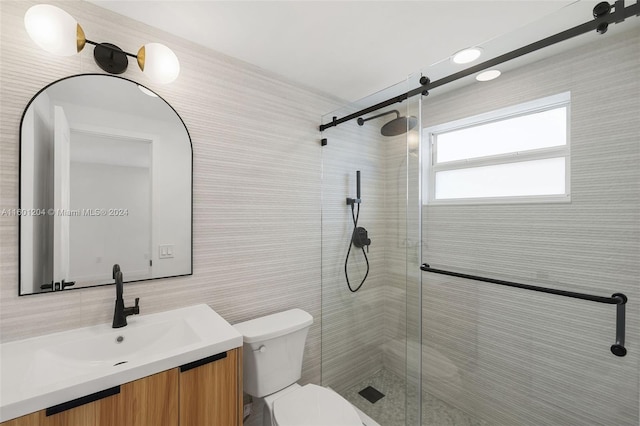 bathroom featuring an enclosed shower, vanity, toilet, and tile walls