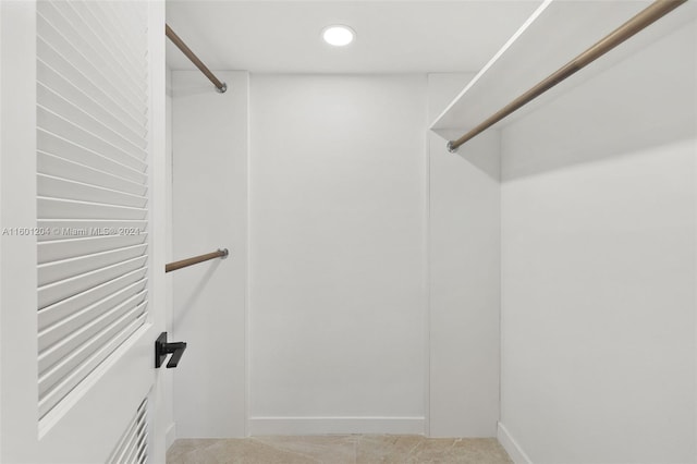 walk in closet featuring carpet