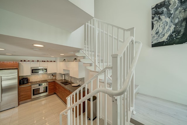 staircase with sink and light tile patterned floors