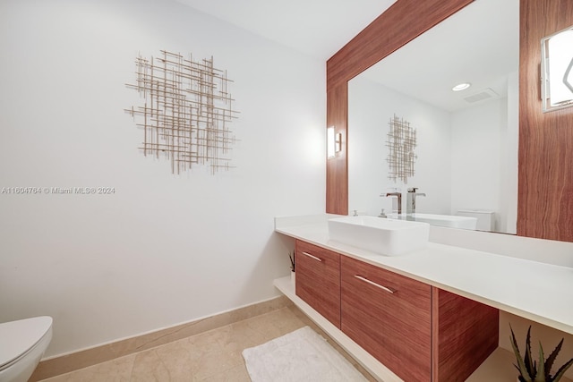 bathroom with tile patterned floors, toilet, and vanity