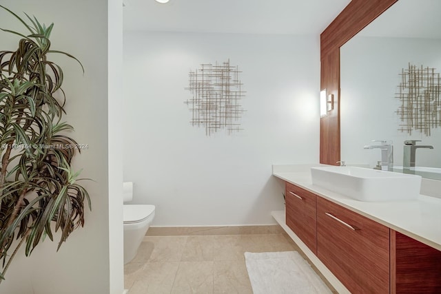 bathroom with vanity, toilet, and tile patterned floors