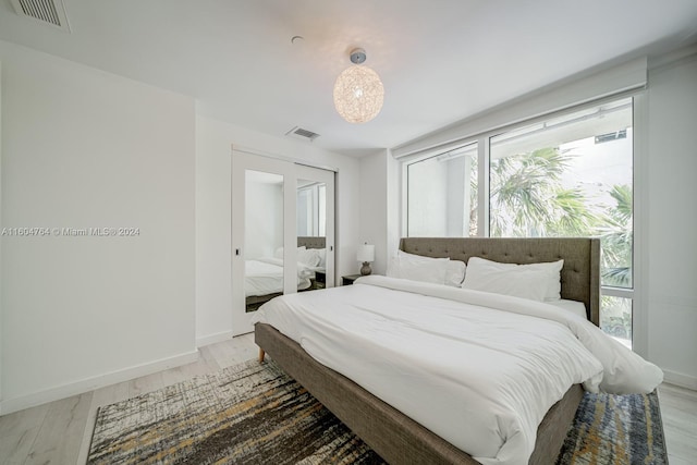 bedroom featuring multiple windows and hardwood / wood-style floors