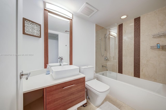 full bathroom featuring tile patterned flooring, tiled shower / bath combo, toilet, and vanity