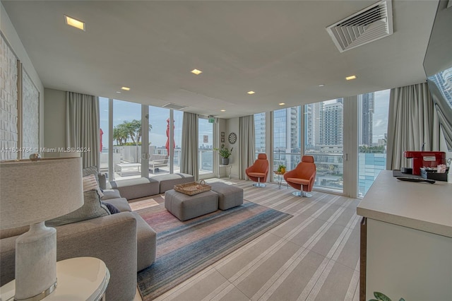 living room with light colored carpet and expansive windows