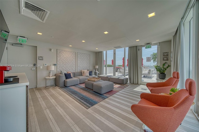 carpeted living room featuring floor to ceiling windows