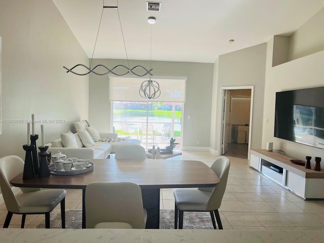 tiled dining space with high vaulted ceiling