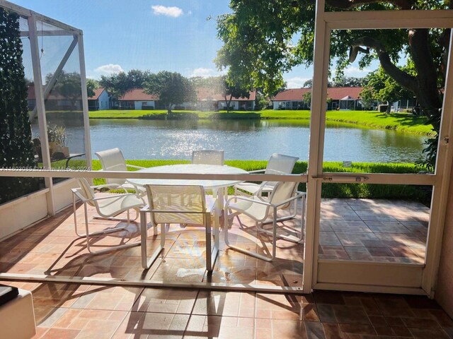 sunroom / solarium with a healthy amount of sunlight and a water view