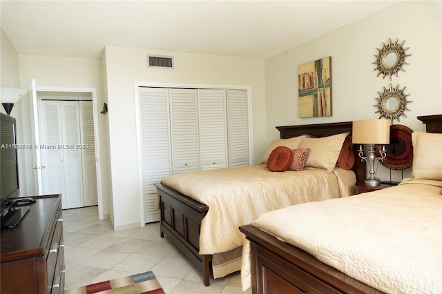 tiled bedroom featuring two closets