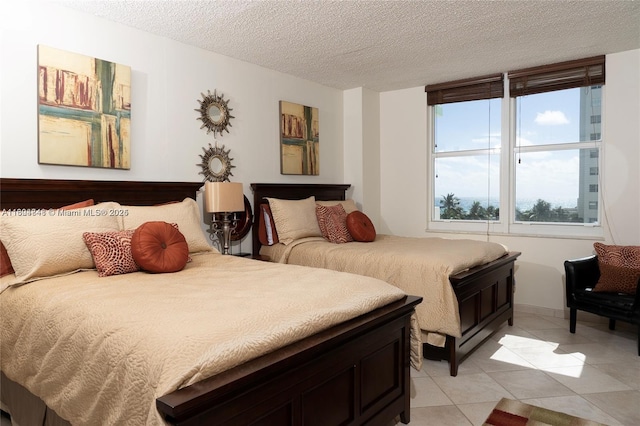 tiled bedroom featuring a textured ceiling