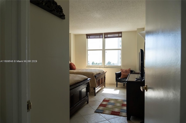 tiled bedroom with a textured ceiling