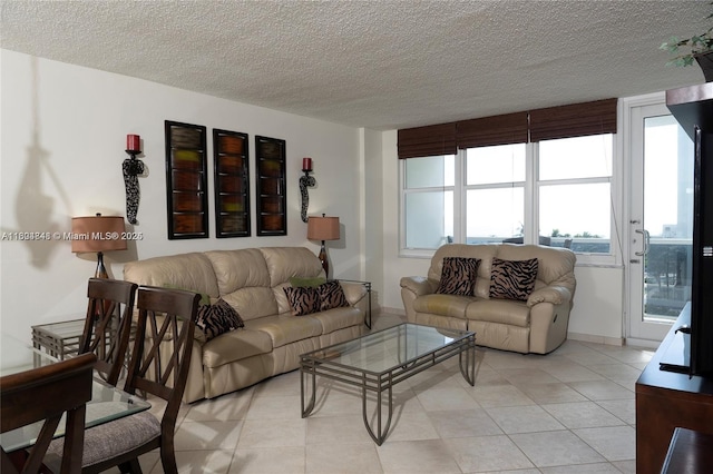 tiled living room featuring a textured ceiling