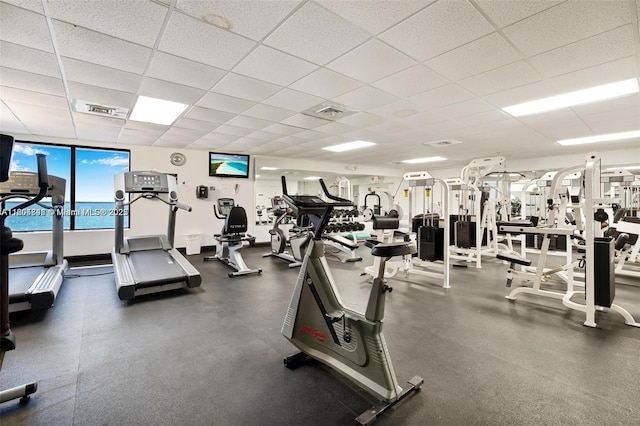 exercise room with a paneled ceiling