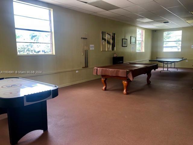 rec room with carpet flooring, a paneled ceiling, and billiards