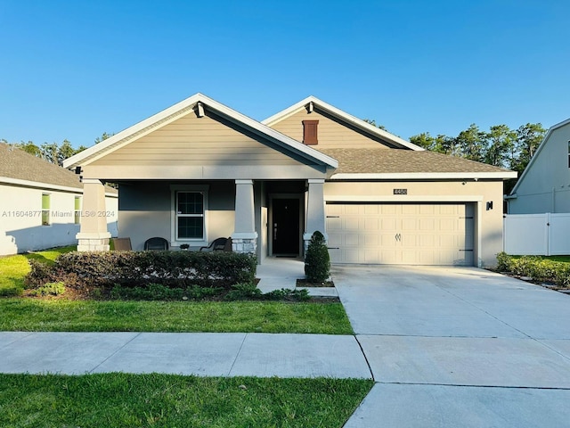 view of front of house with a garage and a front lawn