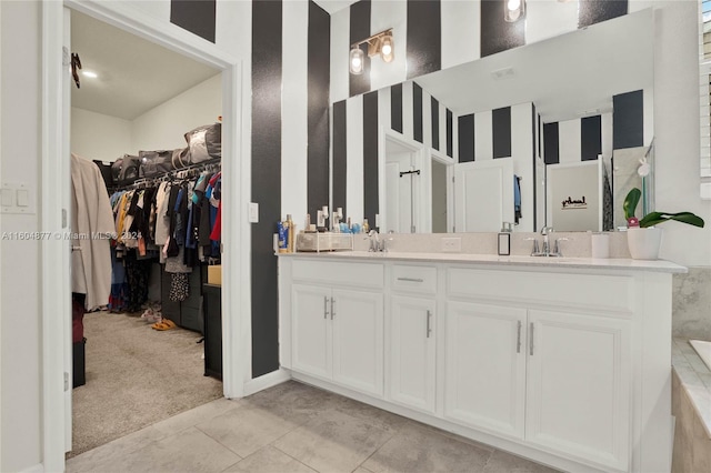 bathroom featuring tile flooring and dual vanity