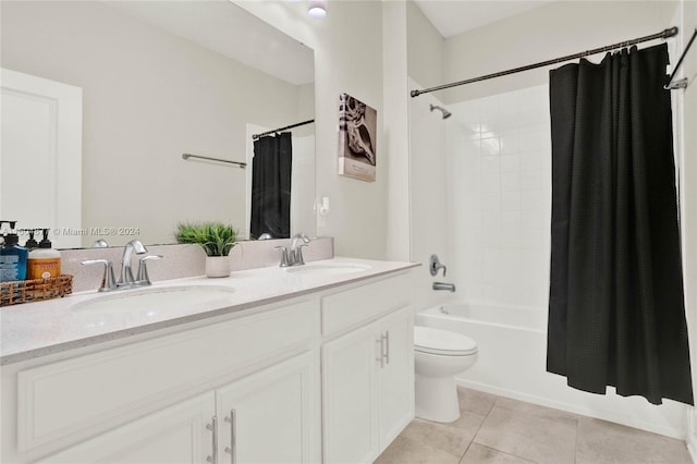 full bathroom featuring dual vanity, tile flooring, toilet, and shower / tub combo