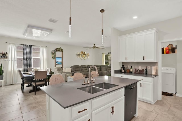 kitchen with washer / dryer, sink, white cabinetry, and dishwasher