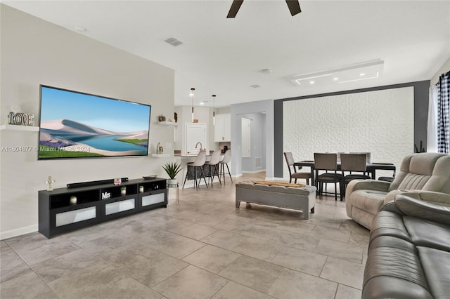 living room with light tile flooring and ceiling fan