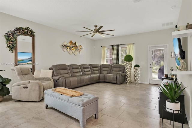 tiled living room with ceiling fan