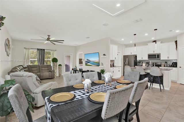 tiled dining space featuring ceiling fan