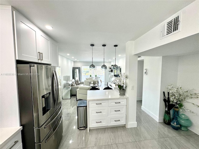 kitchen featuring white cabinetry, decorative light fixtures, stainless steel fridge with ice dispenser, and light tile floors