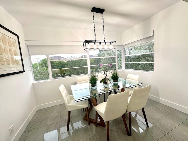 dining room with tile flooring and a chandelier