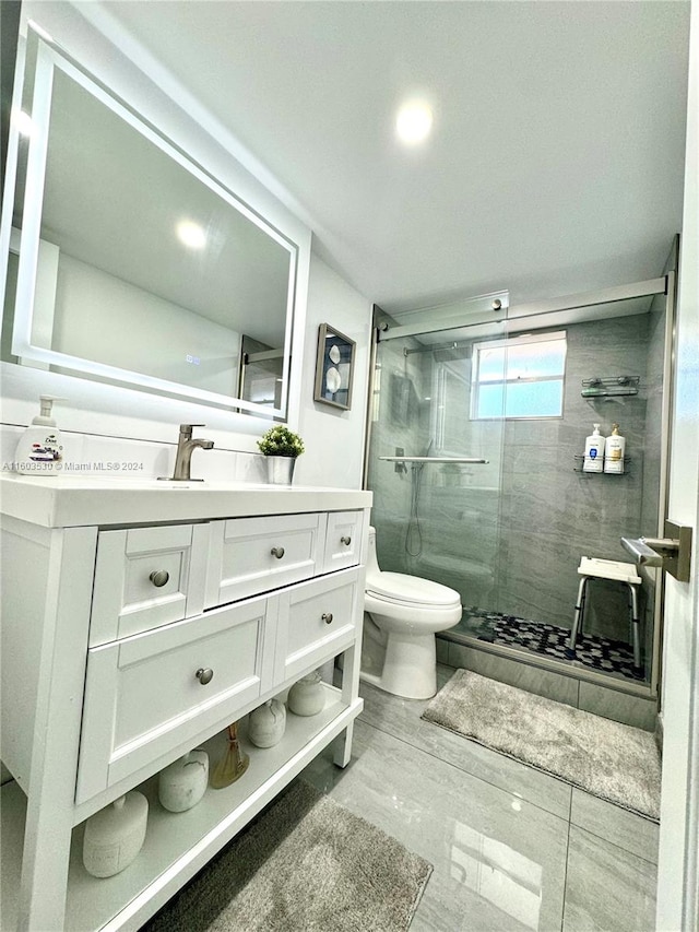 bathroom with tile flooring, walk in shower, vanity, and toilet