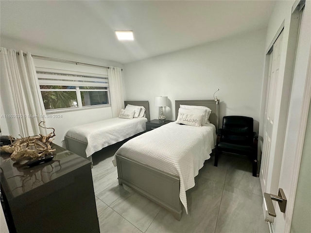 tiled bedroom featuring a closet