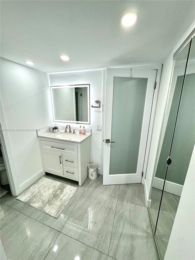 bathroom with tile flooring and vanity