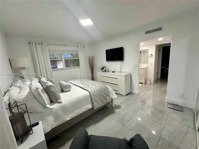 tiled bedroom with connected bathroom