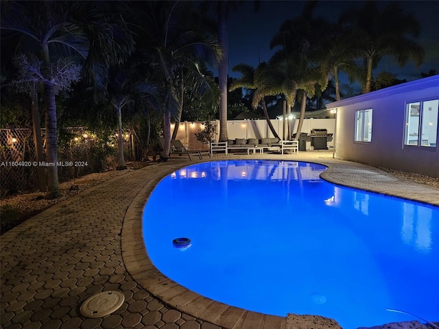 pool at night with a patio