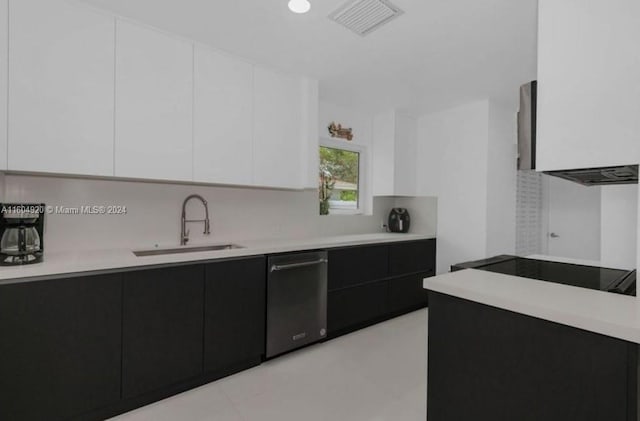 kitchen with light tile patterned floors, backsplash, sink, white cabinetry, and black electric cooktop