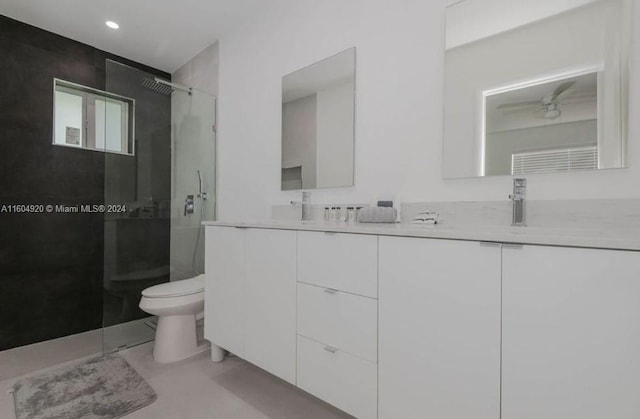 bathroom featuring vanity, toilet, and an enclosed shower